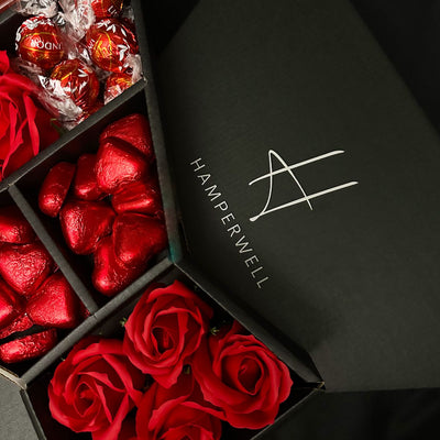 Sneak peak of Lindt Lindor Signature Chocolate Bouquet With Red Roses, showing swiss milk chocolate hearts and truffles