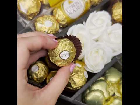 Video showing contents of Ferrero Rocher Signature Chocolate Bouquet With Ivory Roses, swiss chocolate hearts, ferrero rocher