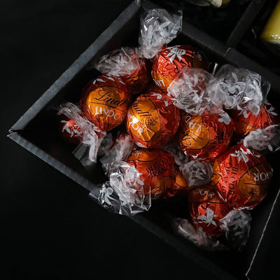 Lindt Lindor & Yankee Candle Signature Chocolate Bouquet With Peach Roses close up of bloody orange chocolate truffles 