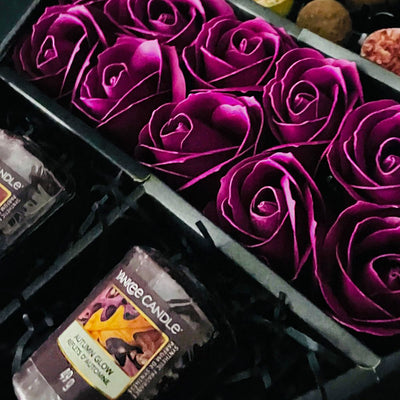 HamperWell Cadbury Heroes & Yankee Candle Signature Chocolate Bouquet With Purple Roses close up of stunning purple roses
