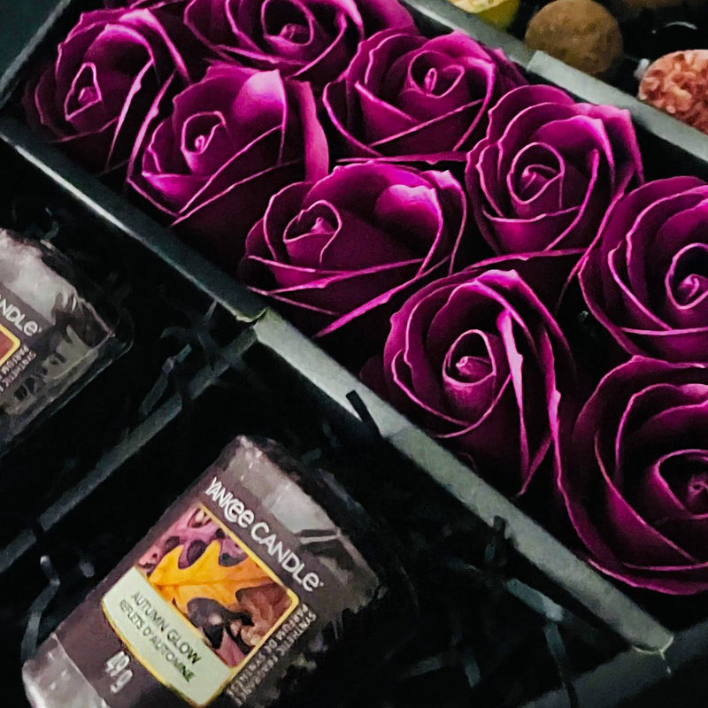 HamperWell Cadbury Heroes & Yankee Candle Signature Chocolate Bouquet With Purple Roses close up of stunning purple roses
