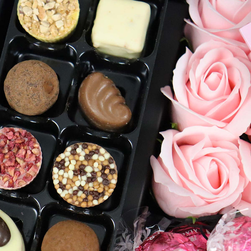 Dolfin Chocolate Ultimate Gift Hamper With Pink Roses close up of truffles and stunning pink roses