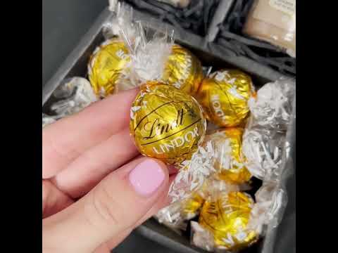 Video showing contents of chocolate bouquet, Lindt Lindor White chocolate truffles, handmade chocolate truffles and candles