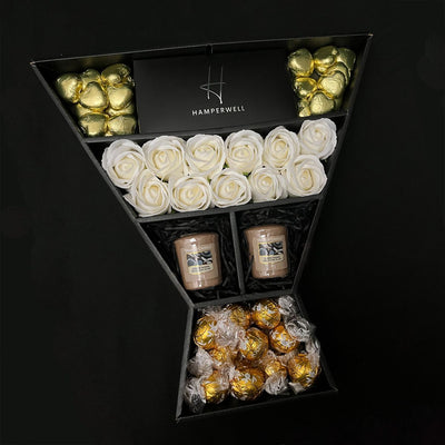 Lindt Lindor & Yankee Candle Signature Chocolate Bouquet With Ivory Roses exclusive to HamperWell on  black background 